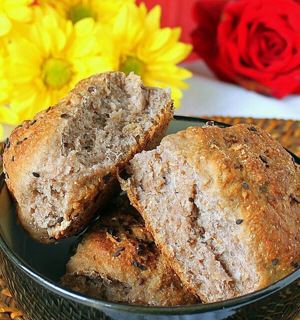 Strawberry cauliflower bread rolls in a dark blow with flowers in the background