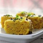 Khaman dhokla slices served on a white plate