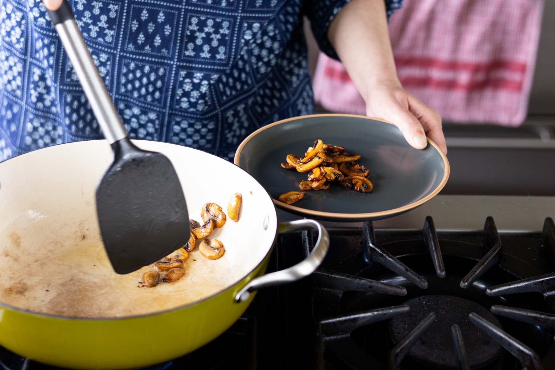 removing the mushrooms from the pan