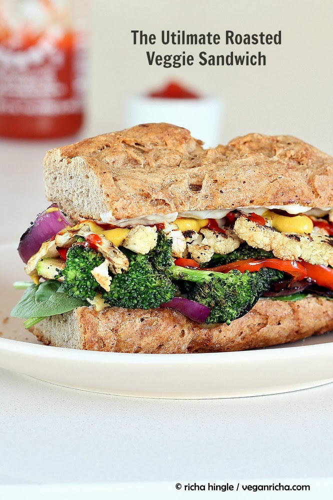 side view of a healthy vegan roasted vegetable sandwich with sriracha mayo and mustard 