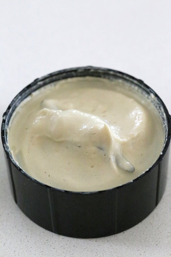 vegan ice cream recipe homemade vegan cashew cream in a black ramekin ready to be used in a vegan ice cream recipe