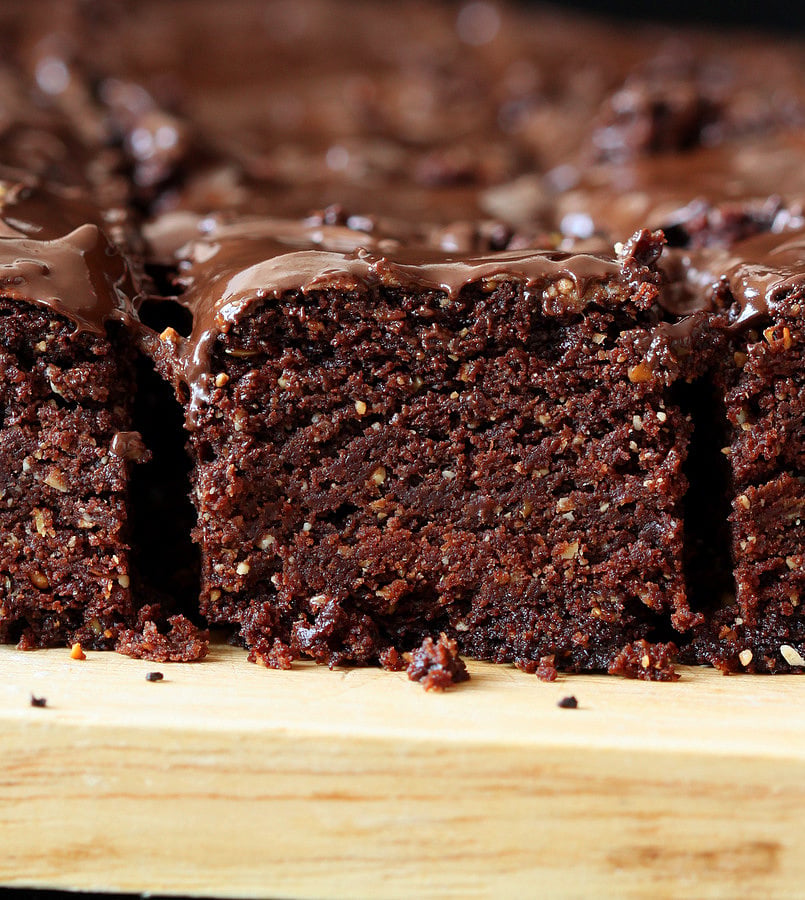 salted caramel brownies side view close-up of Triple Chocolate Salted Caramel Brownies with chocolate glaze