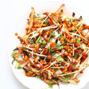 Baked Vietnamese fries. Baked Potato strips, loads of cilantro and basil, bean sprouts, nuts in sweet chile sauce, sriracha and vegan mayo! Banh mi Sandwich in fries form. Vegan Gluten-free Recipe. | VeganRicha.com #vegan #glutenfree #veganricha