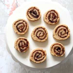 Vegan Cinnamon Roll Cookies. Soft shortbread like cookie dough dusted with cinnamon sugar, rolled, sliced and baked for cinnamon roll bites. #Vegan #Soyfree #VeganRicha #Recipe.