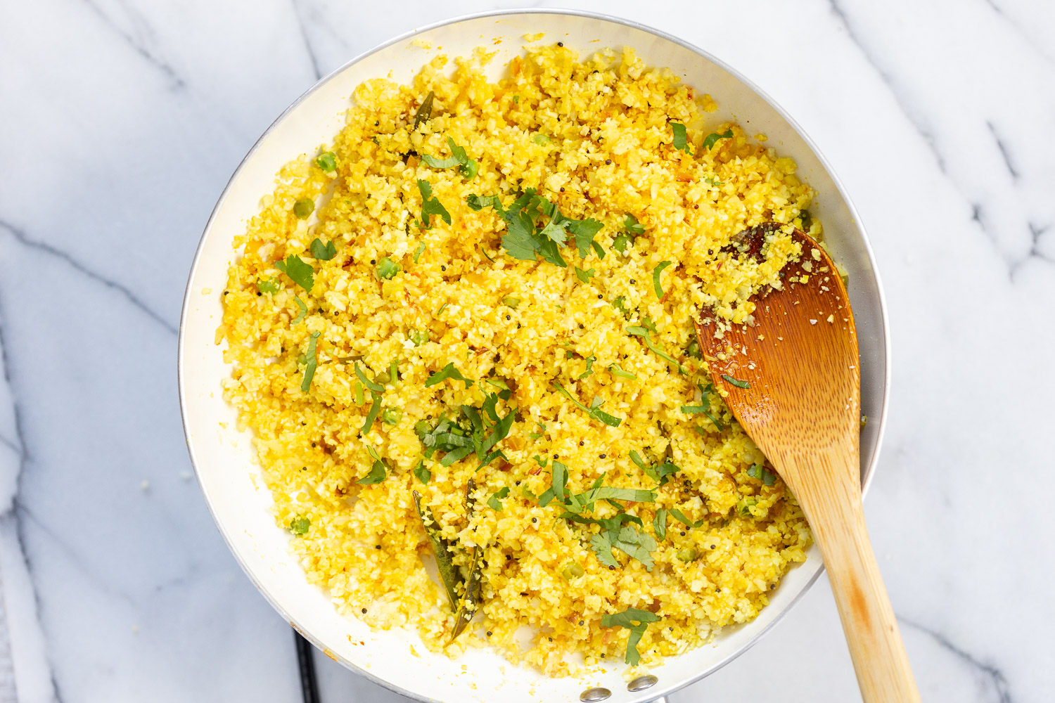 Our Turmeric Cauliflower Rice cooked in a white skillet