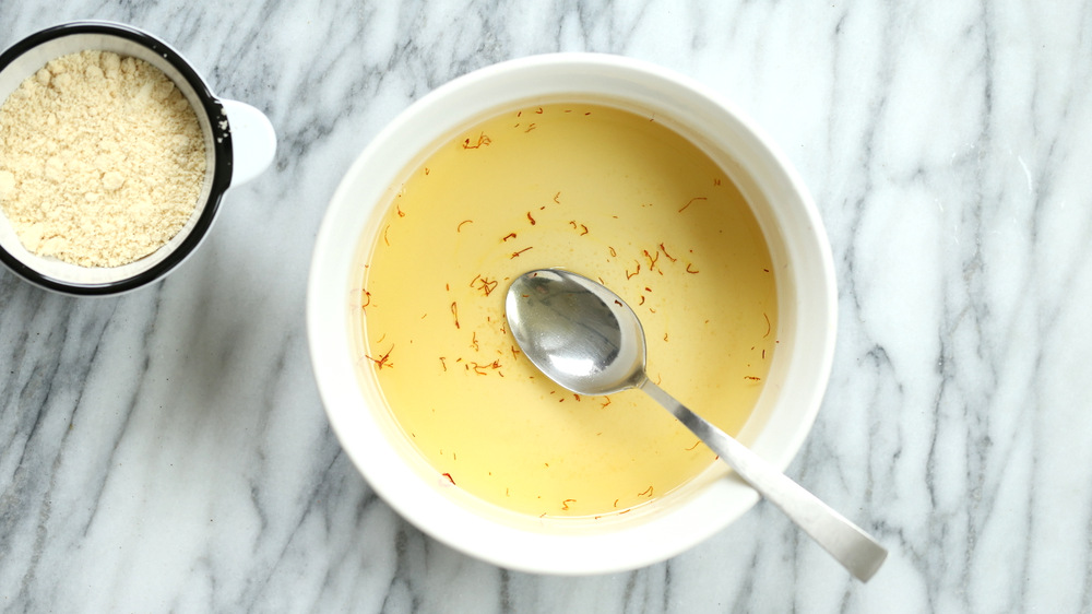 Sugar and saffron mixture for our Almond Halwa in white baking dish