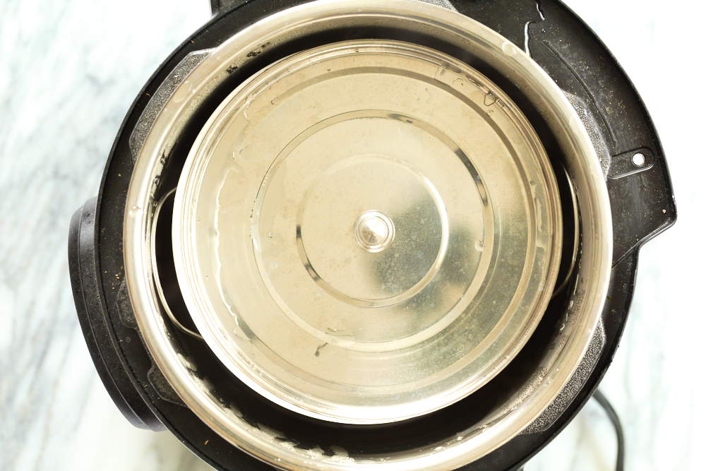 Baking dish for our almond halwa covered with a stee lplate
