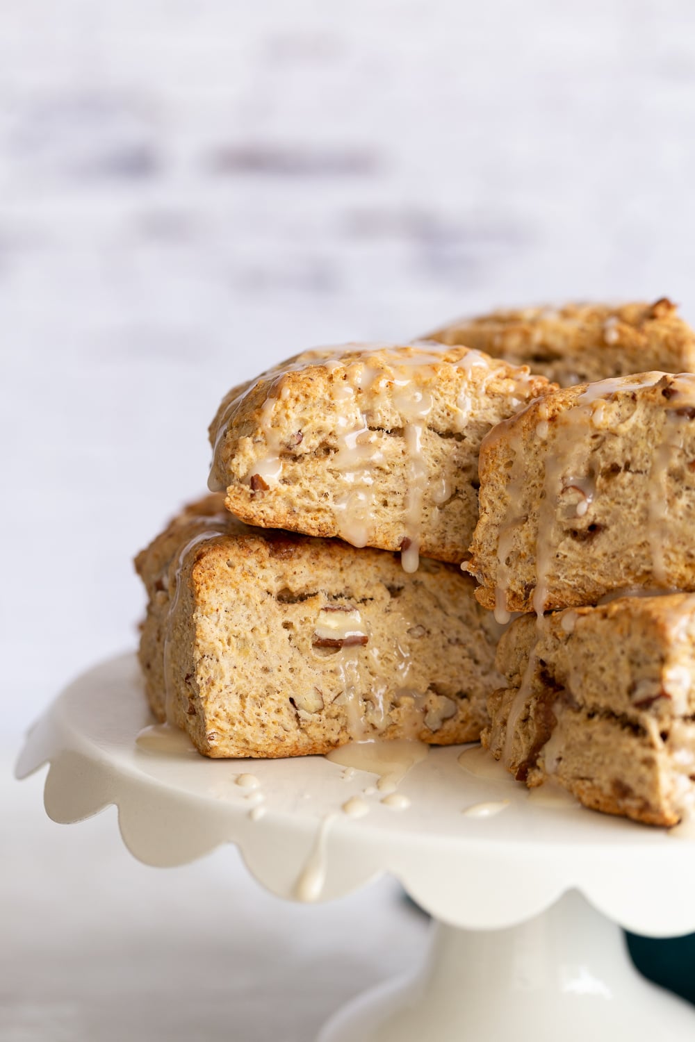 banana scones close up side view of vegan banana scones on a white cake stand