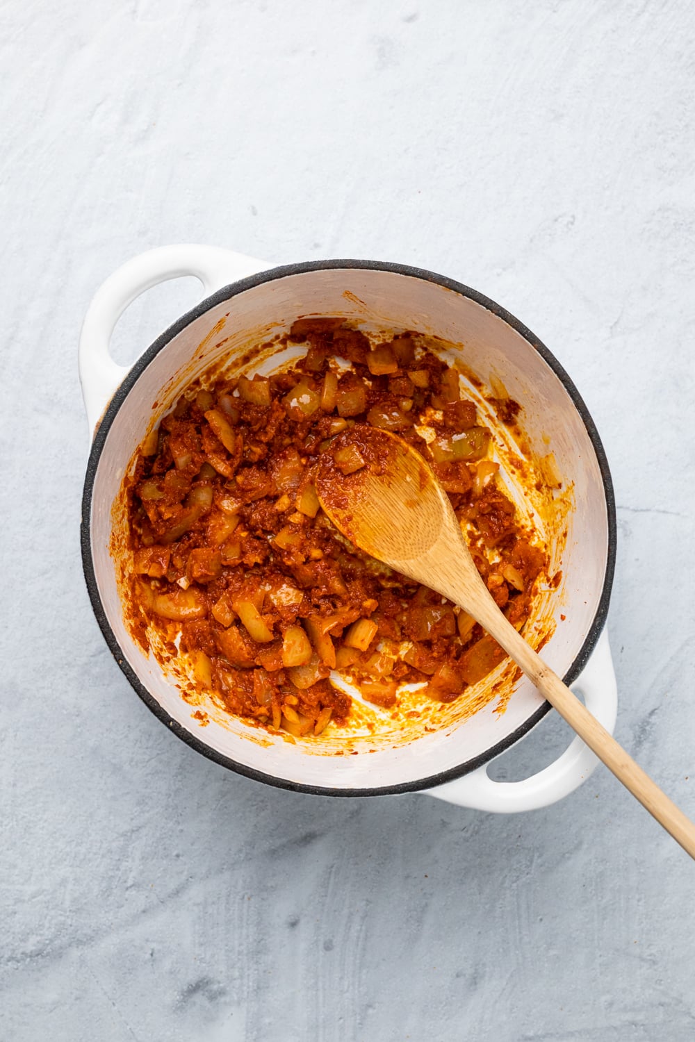 sweet potato curry onions being sauteed with red curry paste
