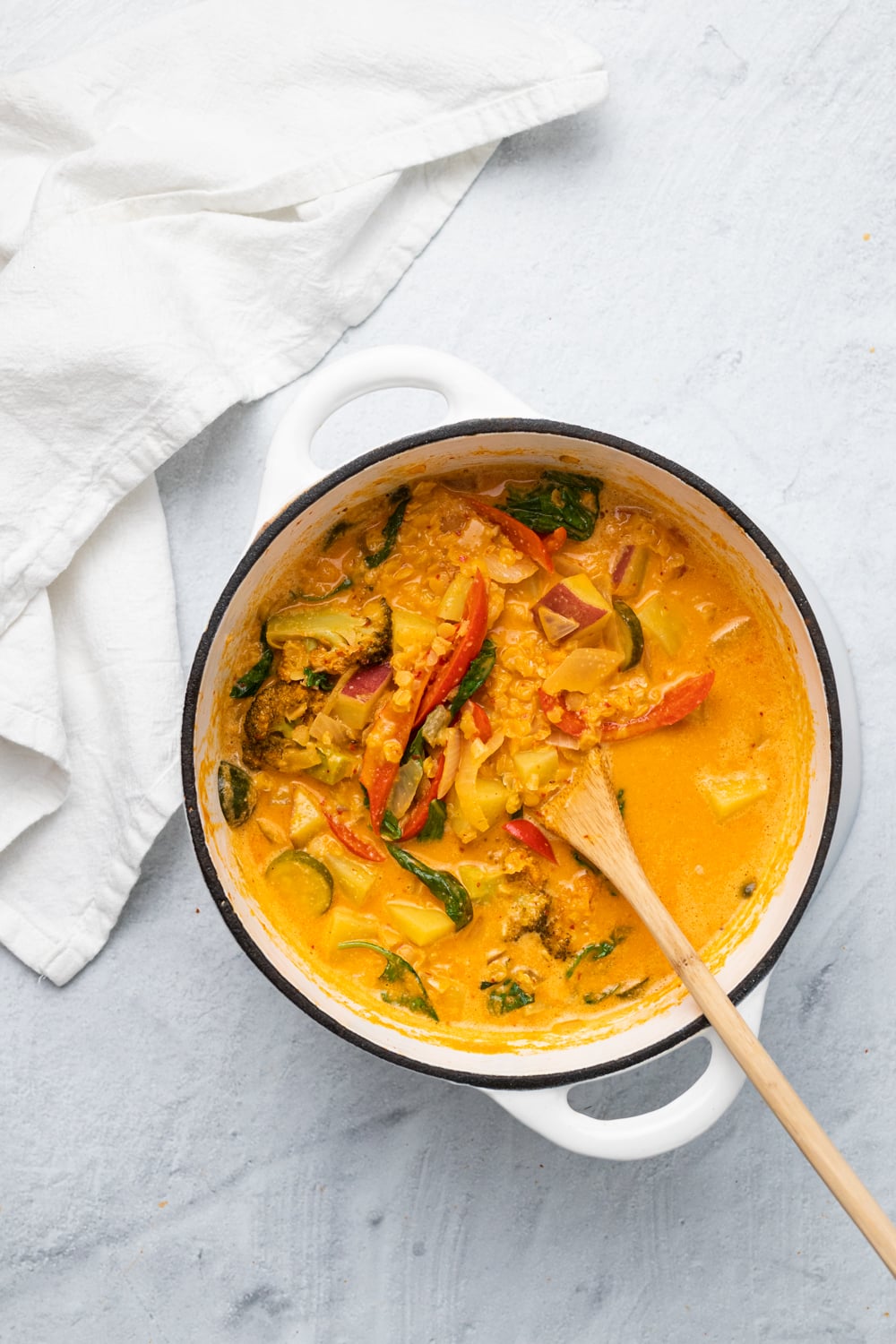 sweet potato curry overhead shot of a white ceramic pot filled with vegan red lentil sweet potato curry