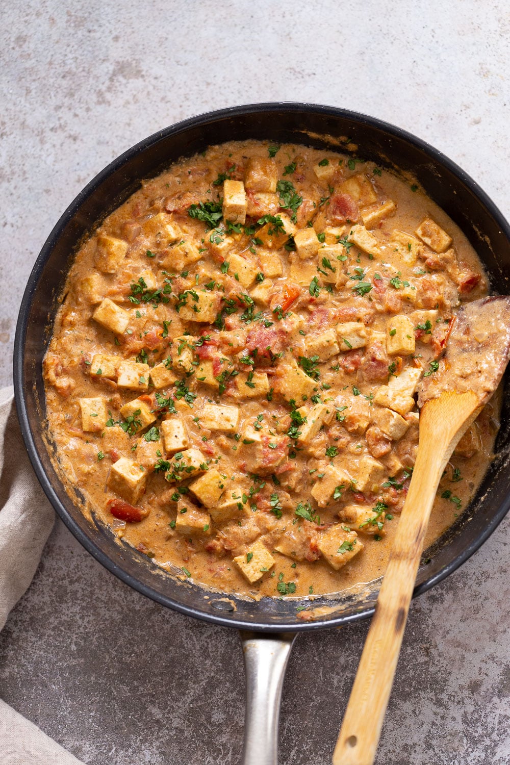 overhead shot of a skillet with tofu in creamy black pepper sauce