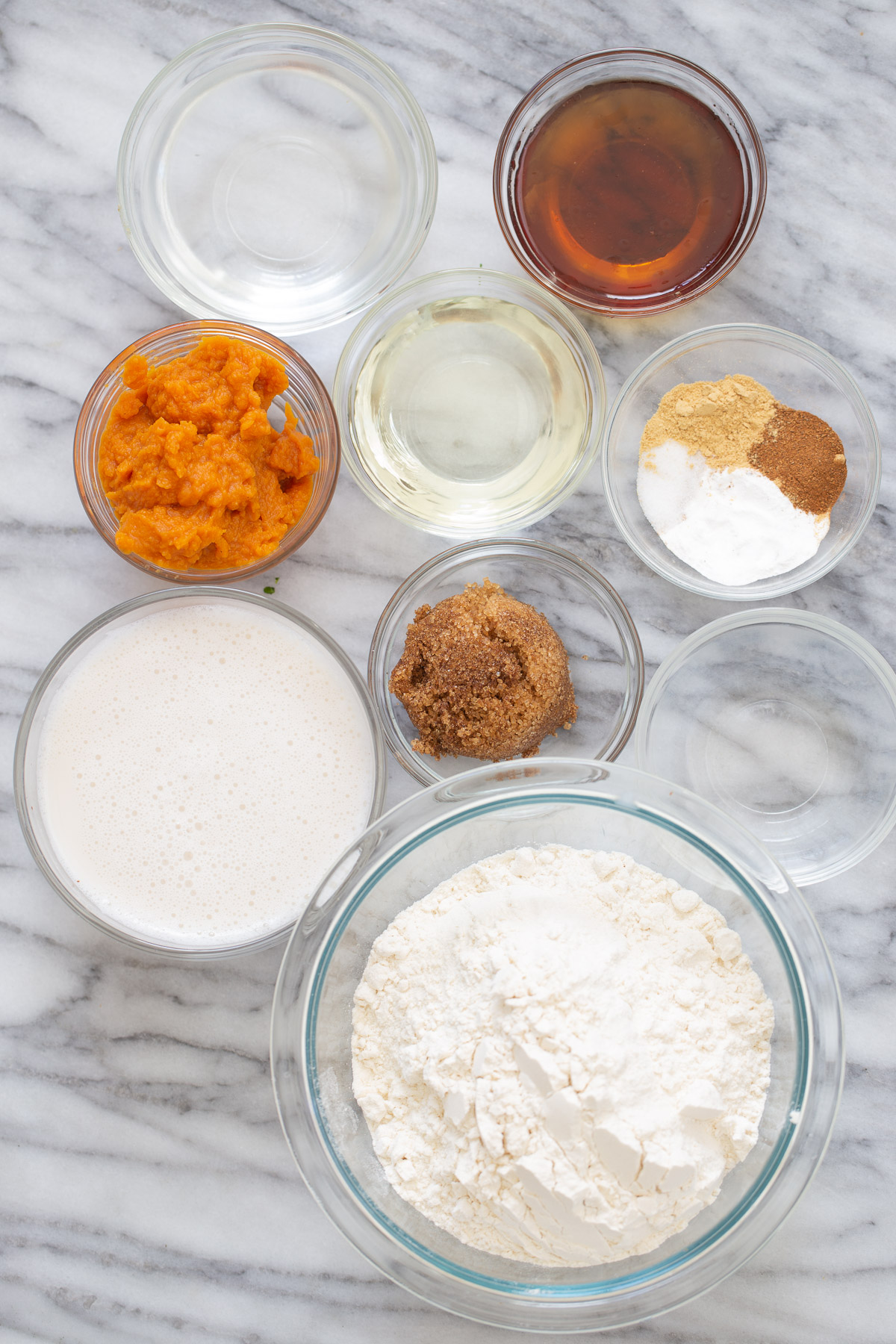 ingredients for vegan pumpkin pancakes on a marble slate