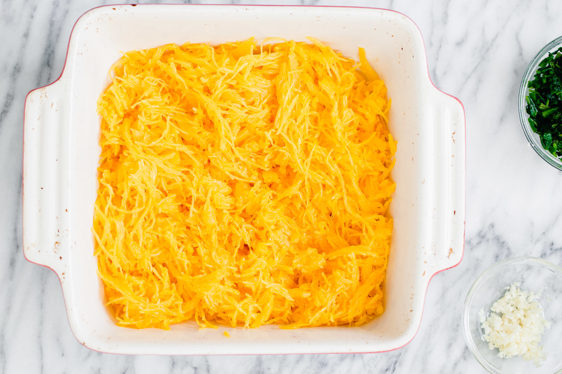 spaghetti squash bake cooked spaghetti squash noodles in a white casserole dish