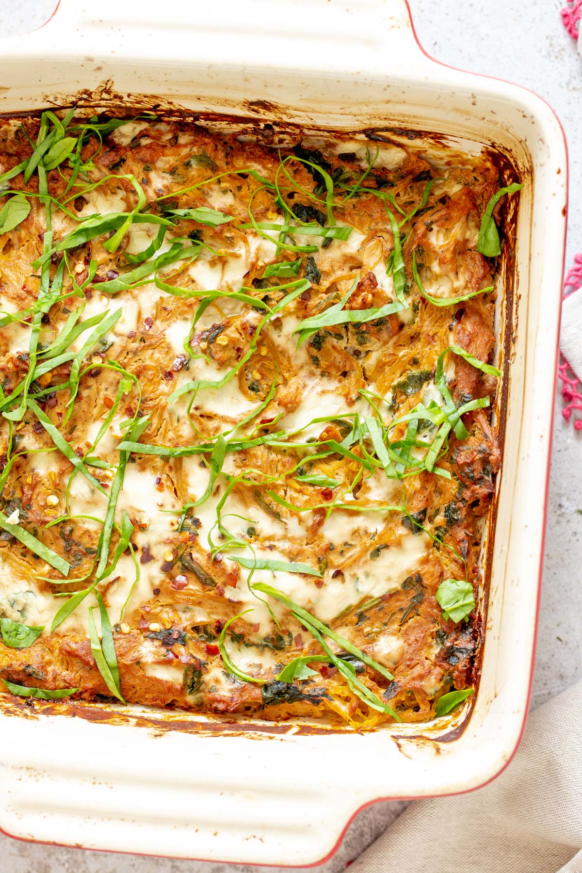 spaghetti squash bake vegan Italian Sun-dried tomato Spaghetti Squash Pasta Bake in a white casserole dish