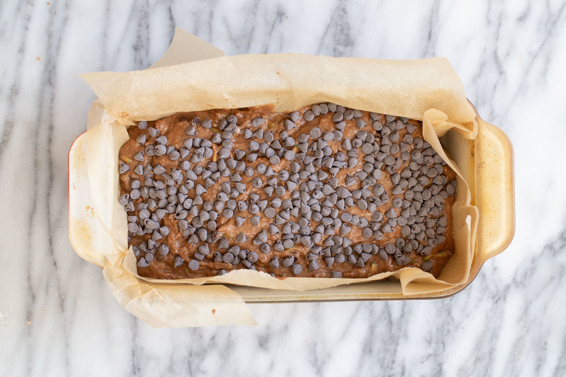 raw unbaked vegan chocolate zucchini bread sprinkled with chocolate chips 
