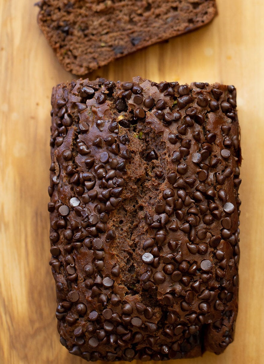 overhead shot of a loaf of vegan chocolate zucchini bread on a chopping board 