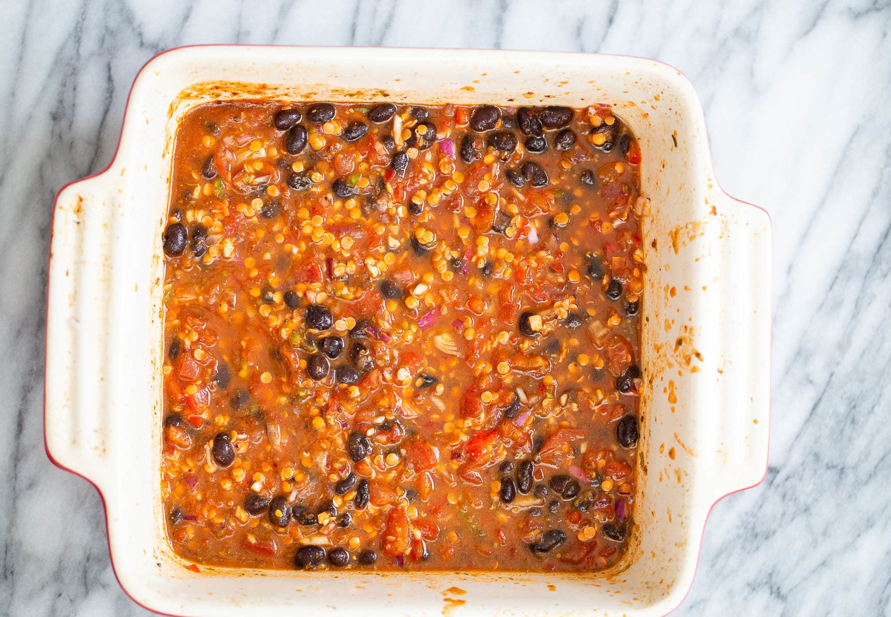 chili mix in white casserole dish for cornbread casserole