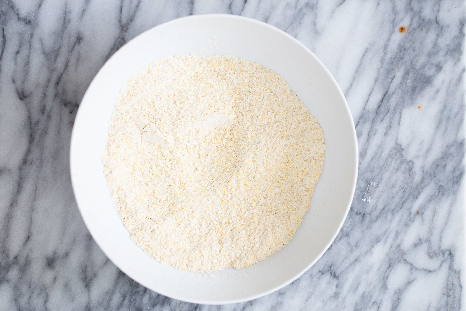 dry cornbread mix in white bowl