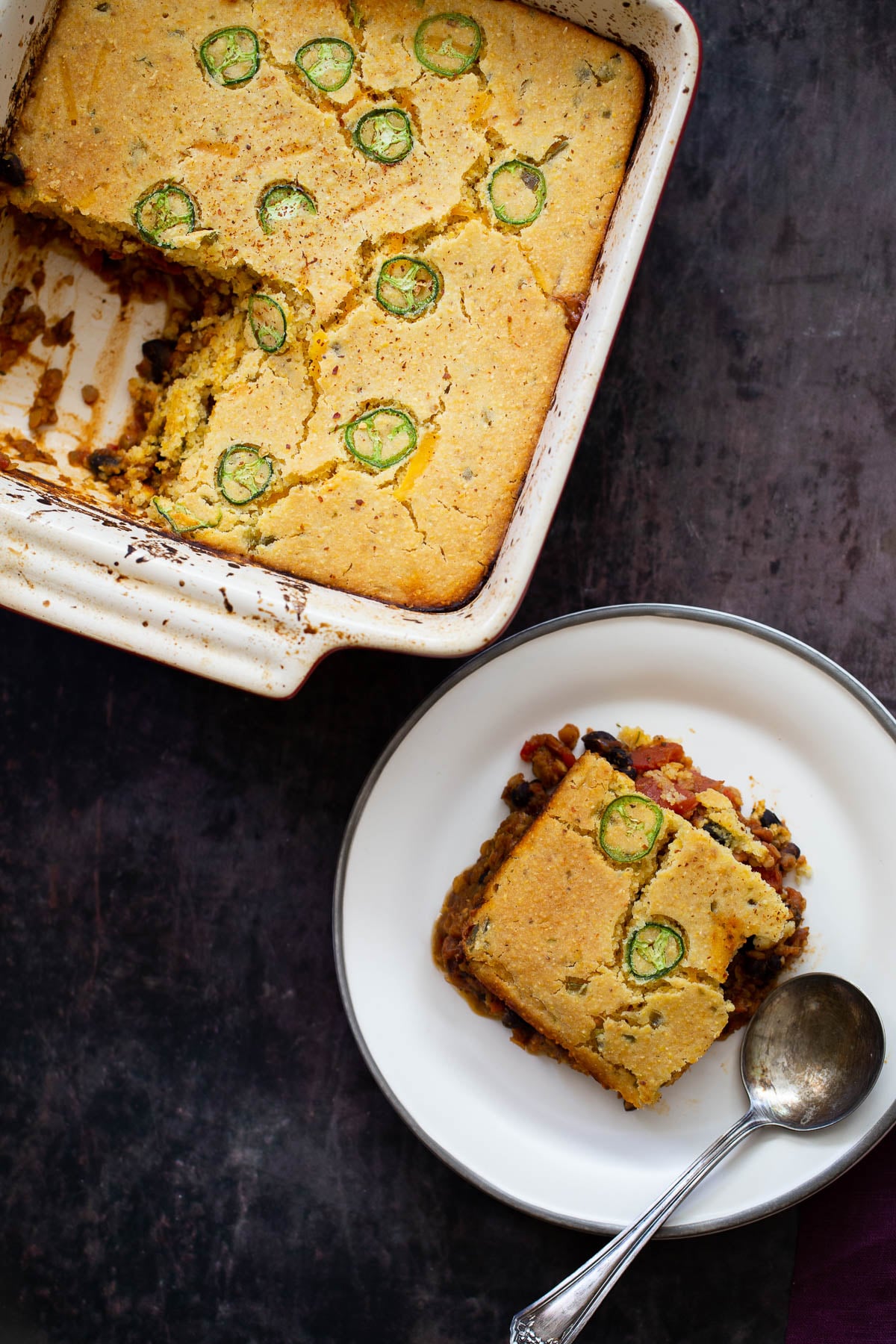 overhead shot of chili cornbread casserole with one square cut