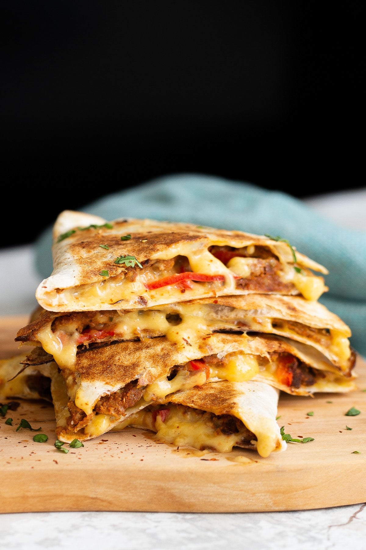 close-up side view of a stack of cut vegan walnut meat quesadillas 