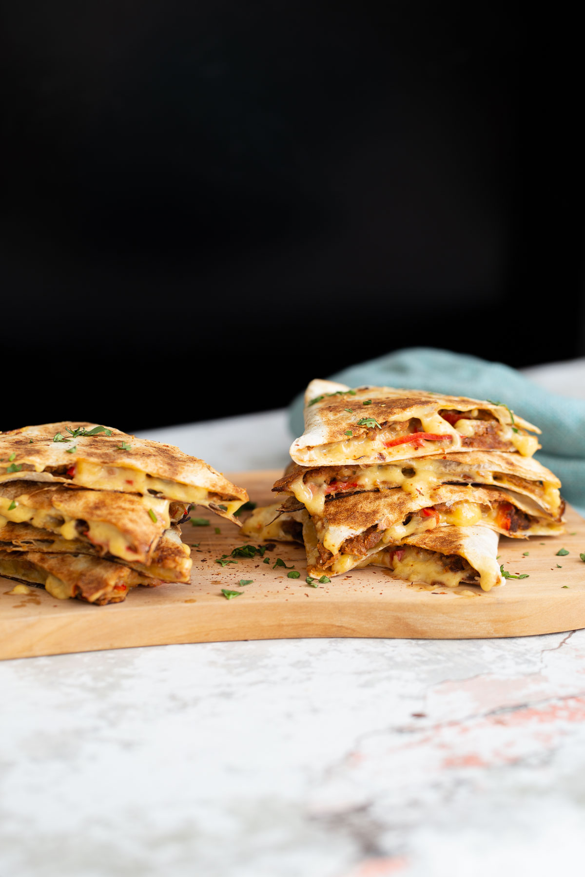 walnut taco meat side view of vegan quesadillas filled with vegan walnut taco meat, bell pepper and melted cheese