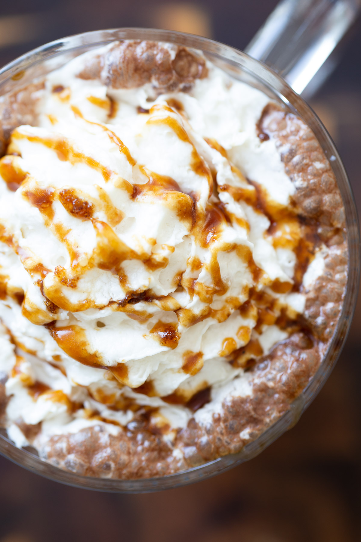 salted caramel mocha overhead shot of a mug of vegan salted caramel mocha topped with whipped coconut cream and caramel syrup