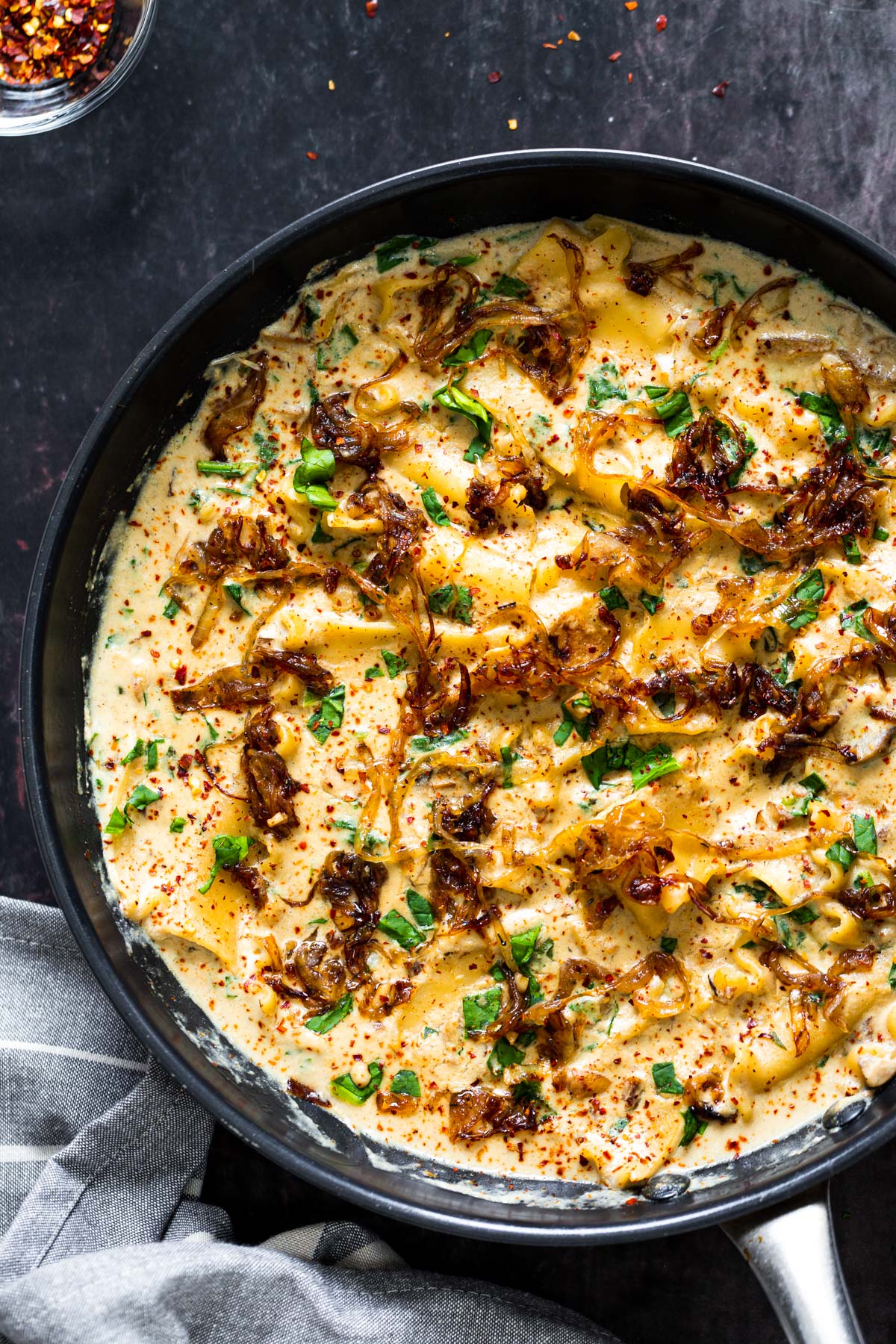 vegan skillet lasagna a skillet with vegan French onion skillet lasagna topped with caramelized onions
