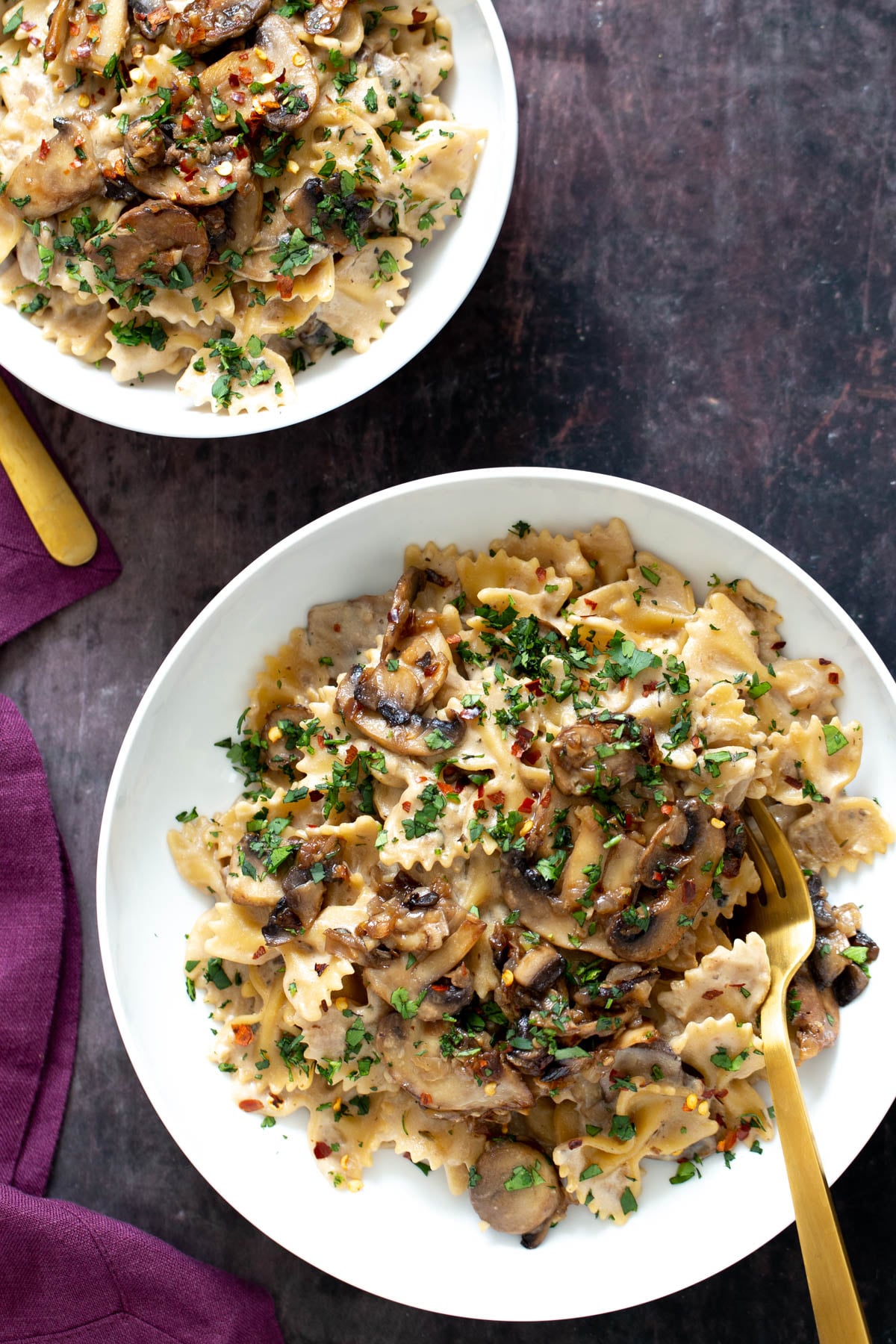 two plates with vegan mushroom stroganoff
