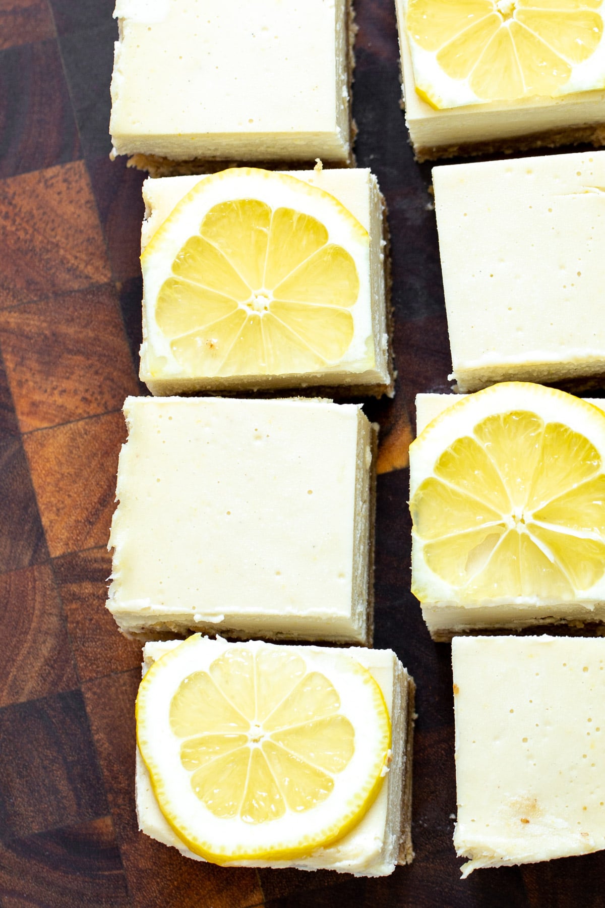 freshly cut vegan lemon bars topped with lemon slices 