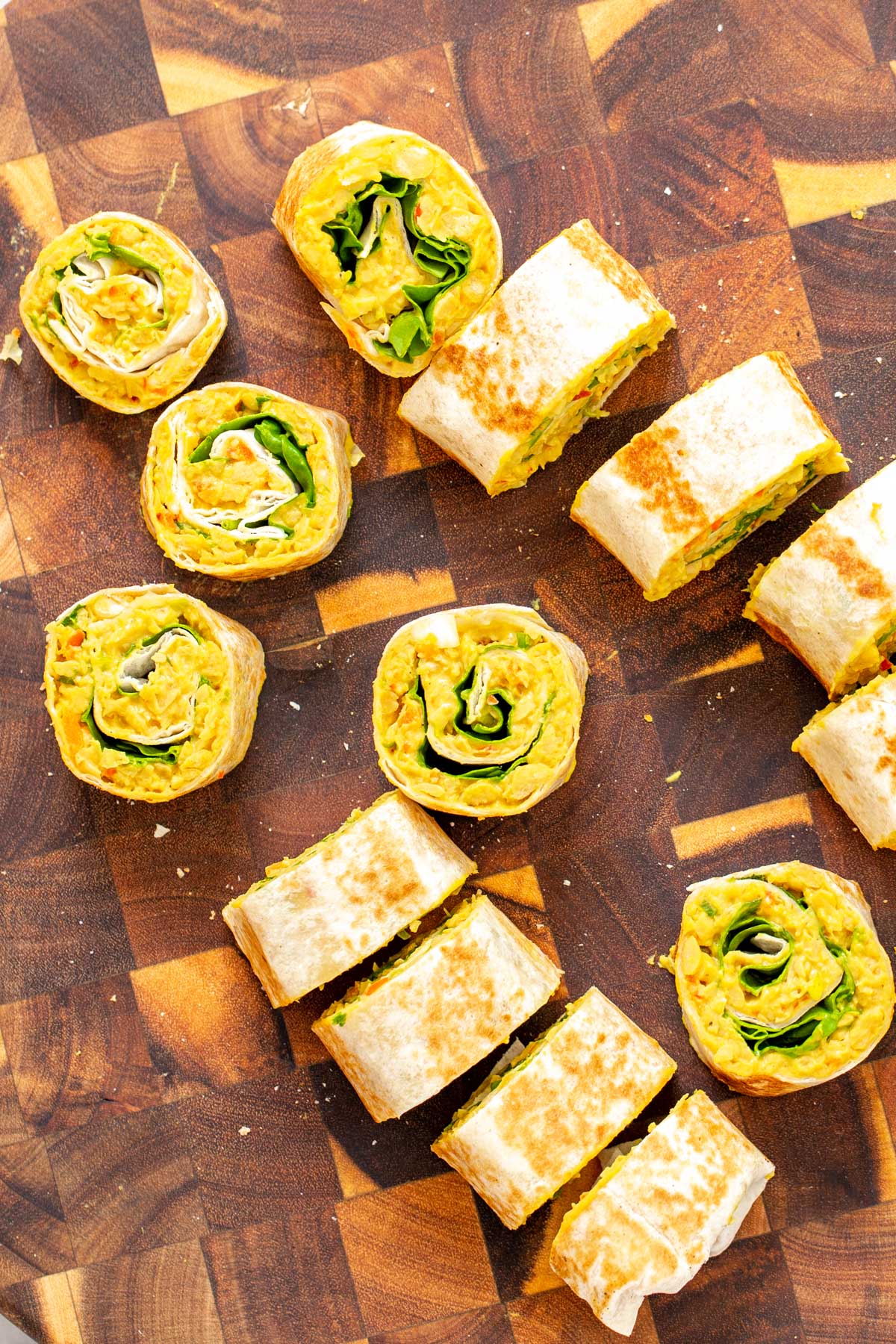 chickpea breakfast vegan chickpea scramble wraps being sliced into pinwheels
