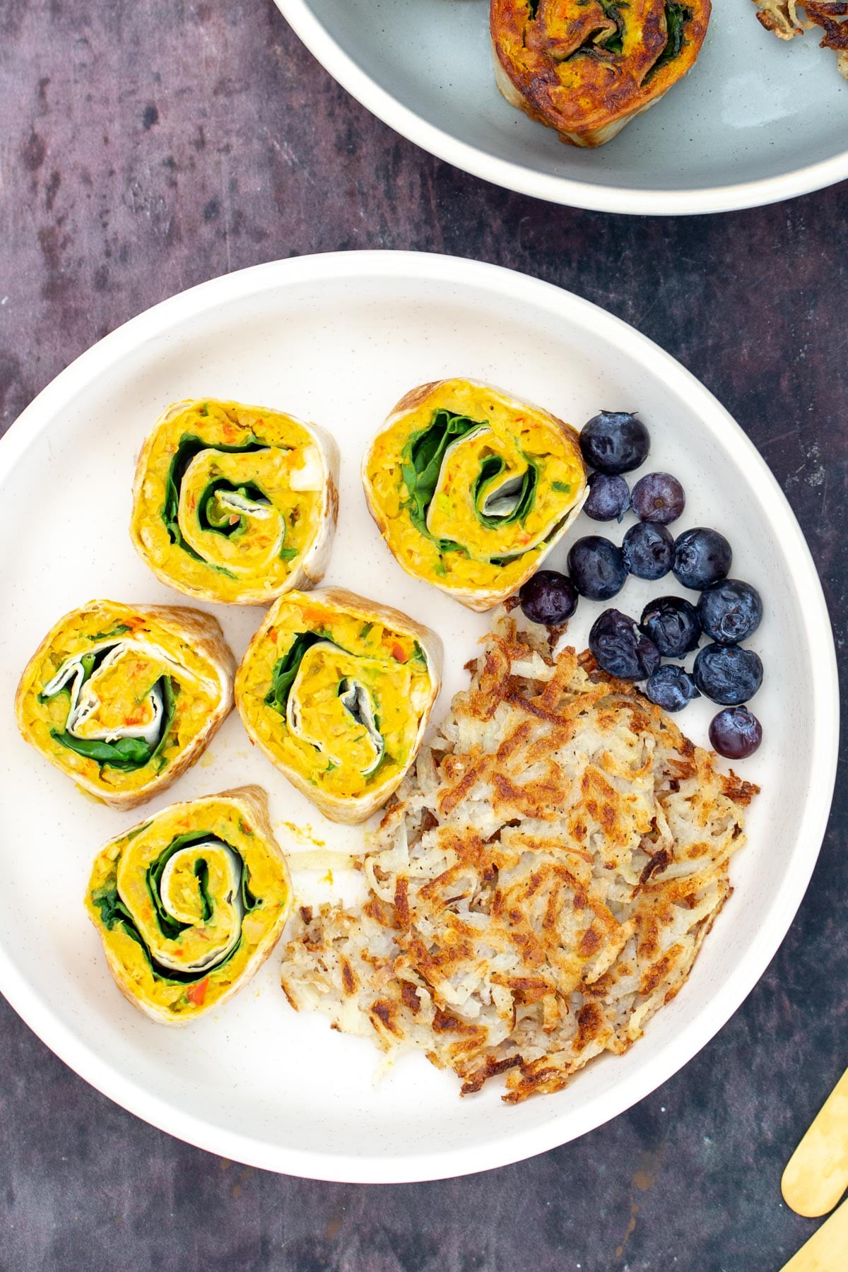 chickpea breakfast vegan chickpea breakfast rolls served on a plate with blueberries and hashbrowns