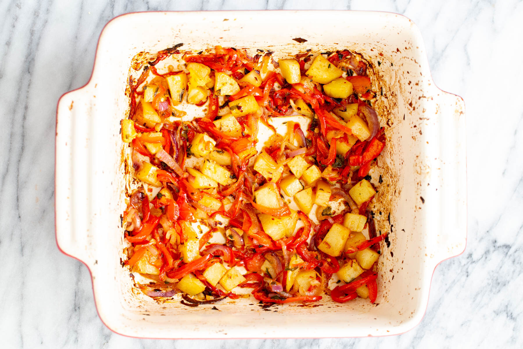 vegan Mexican casserole roasted bell peppers, onion and potatoes in a casserole dish