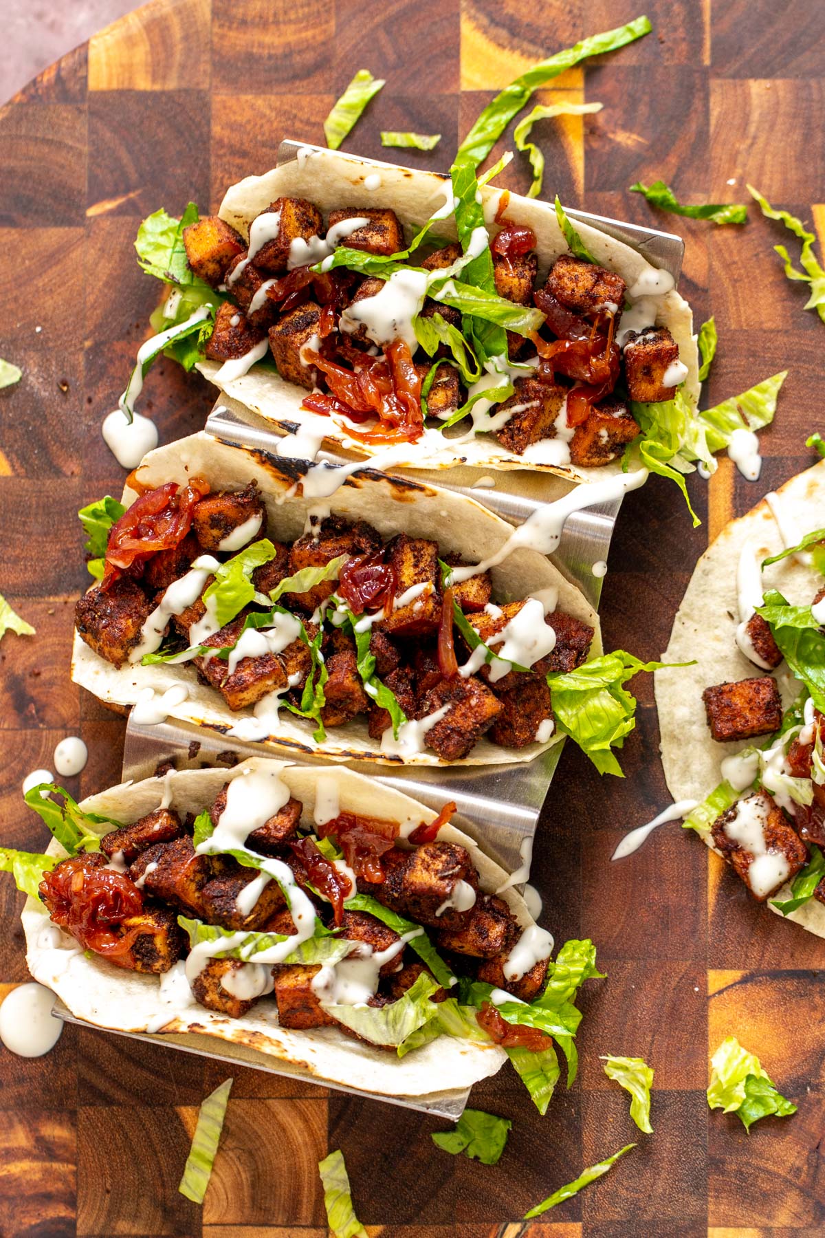 blackened tofu overhead shot of vegan blackened tofu tacos drizzled with vegan sour cream
