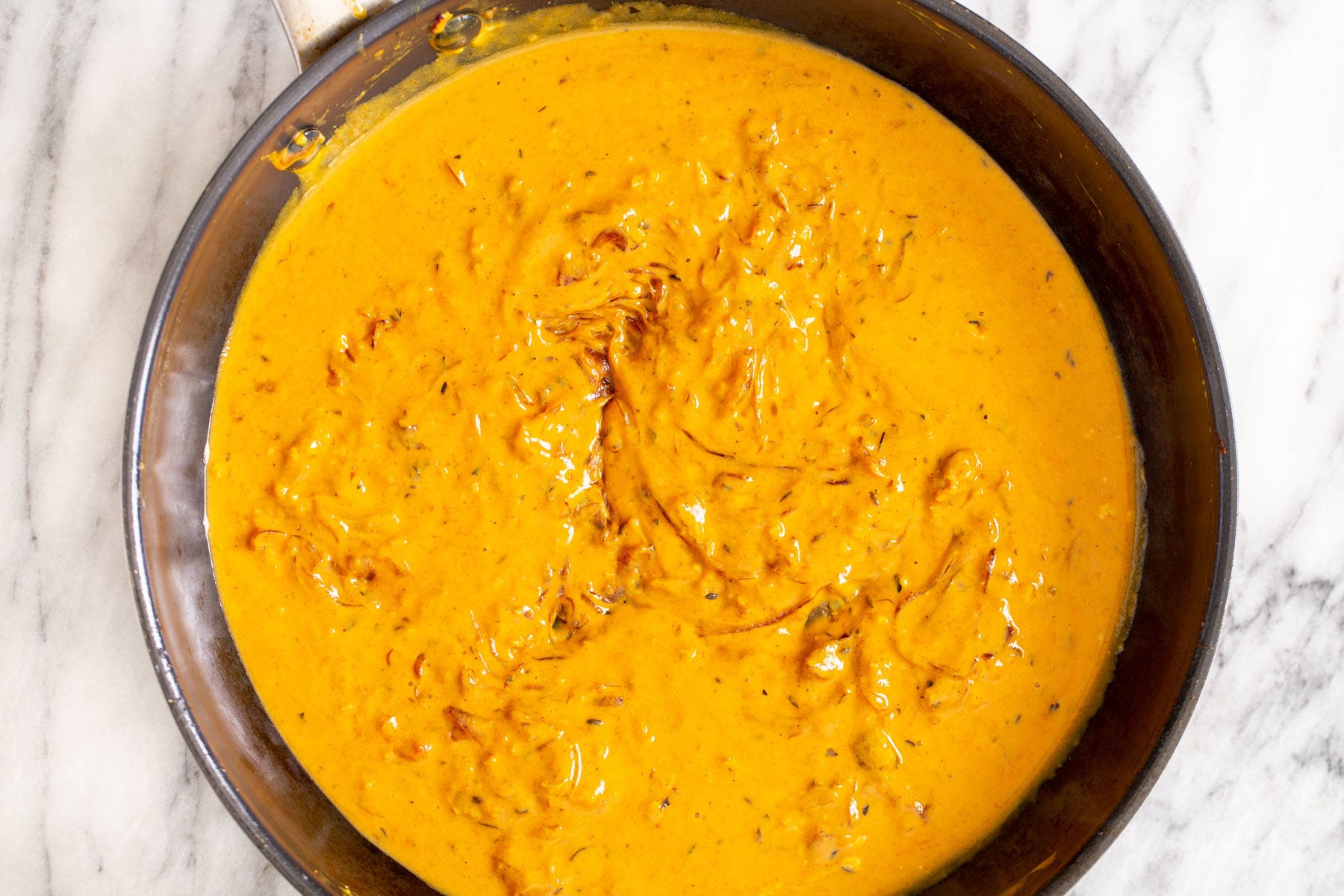 cauliflower in tomato yogurt gravy in a black skillet