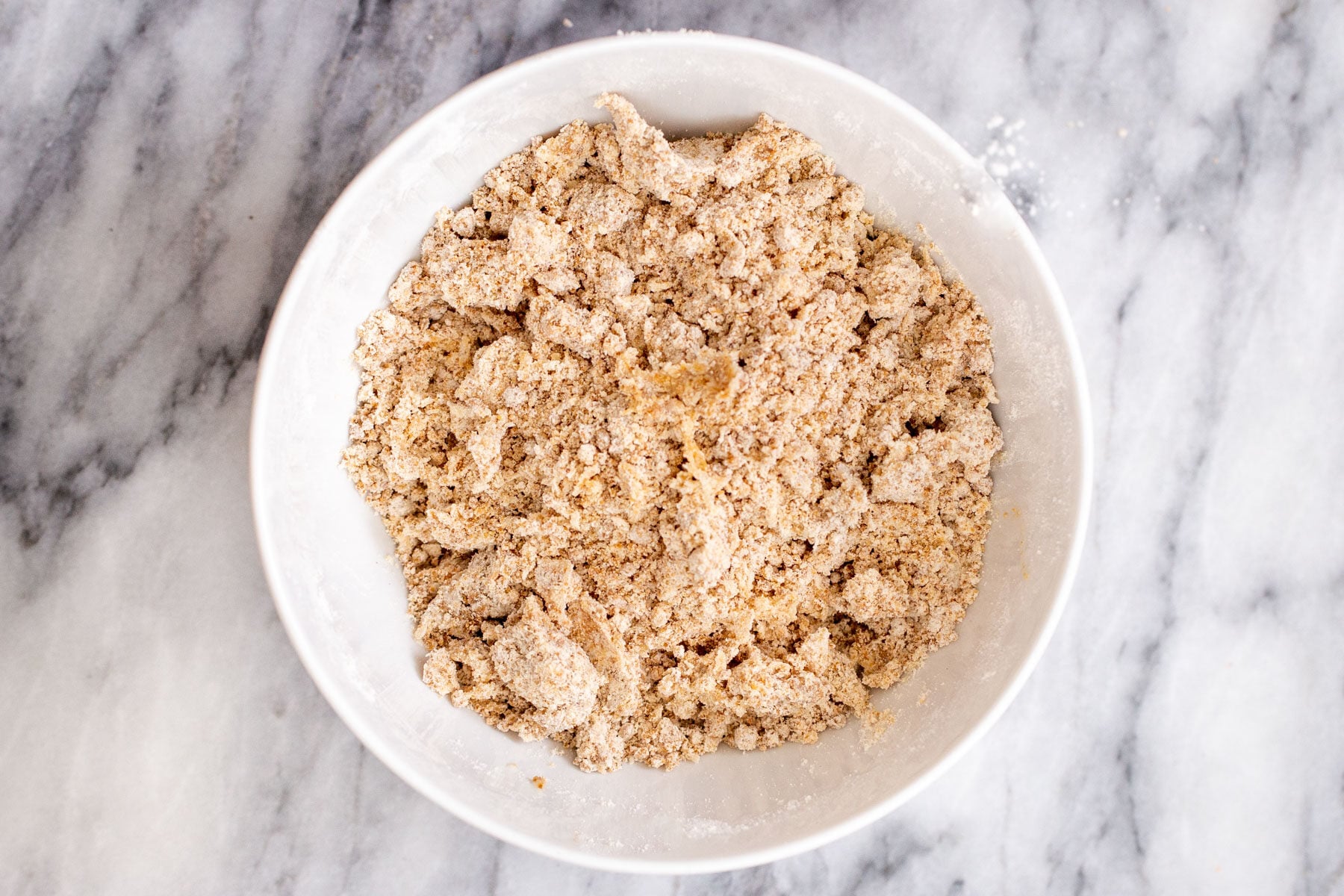 vegan apple pie bars crust in a white bowl