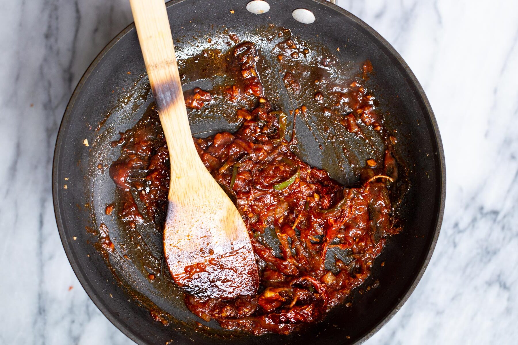 vegan chicken kondattam sauce in a black frying pan