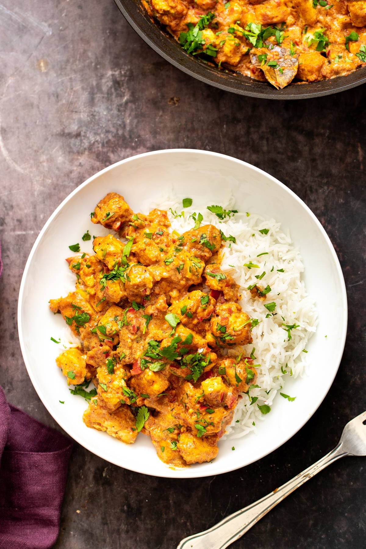 vegan rogan josh served with rice and sprinkled with cilantro