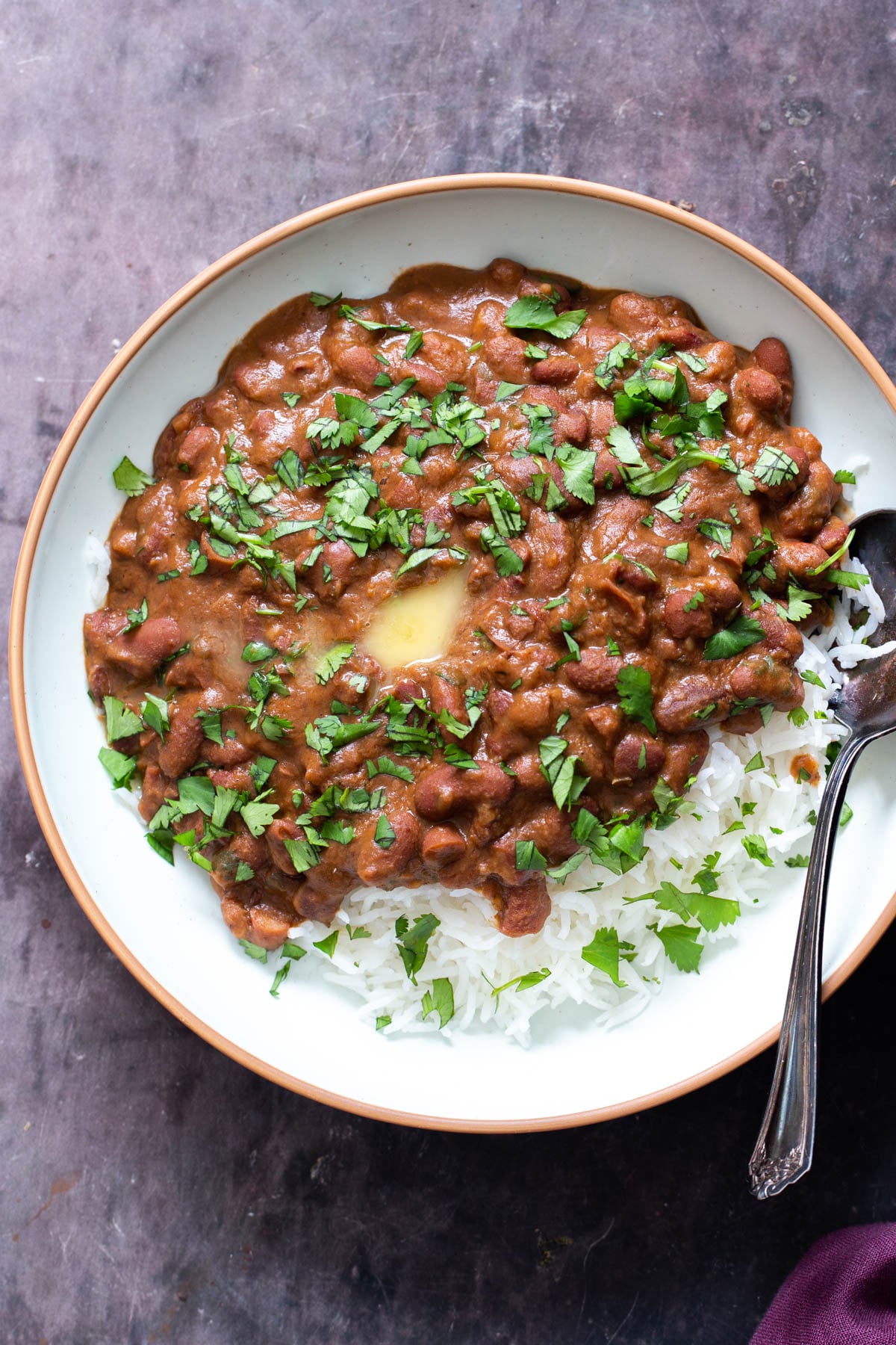 overhead shot of a plate of red kidney bean curry served with rice 