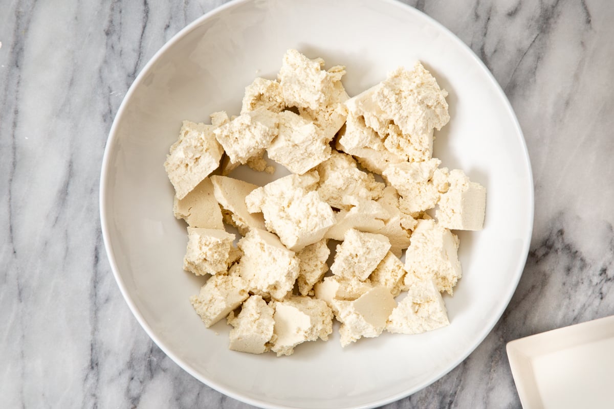 pieces on torn-up firm tofu in a white bowl