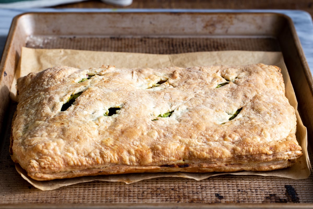 freshly baked vegan samosa pie on a baking sheet 