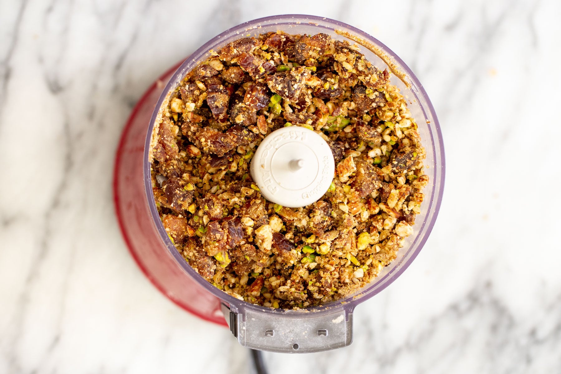 chopped nuts and dates in a small food processor 