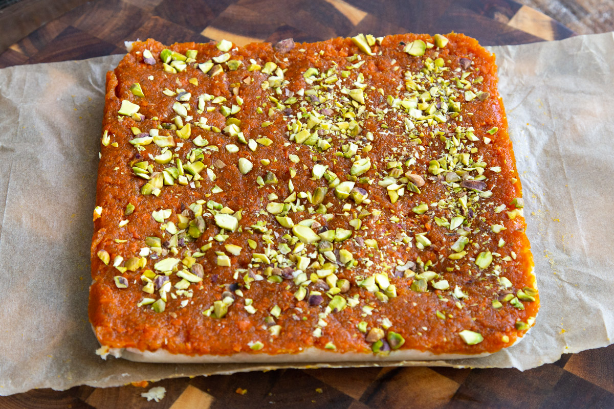 coconut burfi carrot halwa bars topped with pistachios
