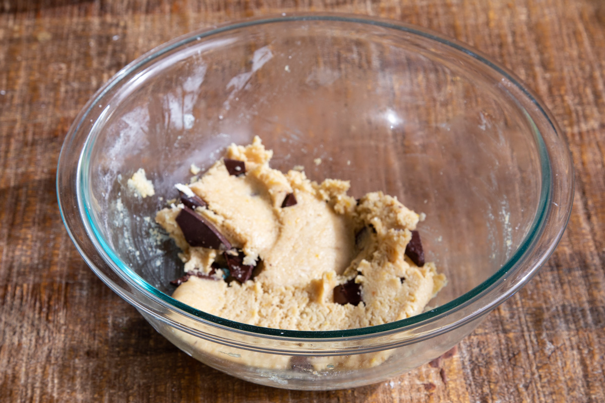 almond flour chocolate chip cookie dough with chocolate chunks in a glass bowl