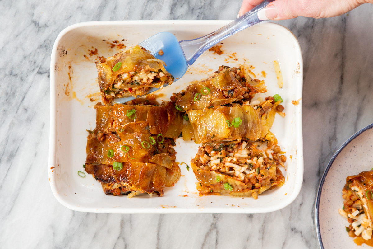 vegan scalloped potato rolls in a white casserole dish
