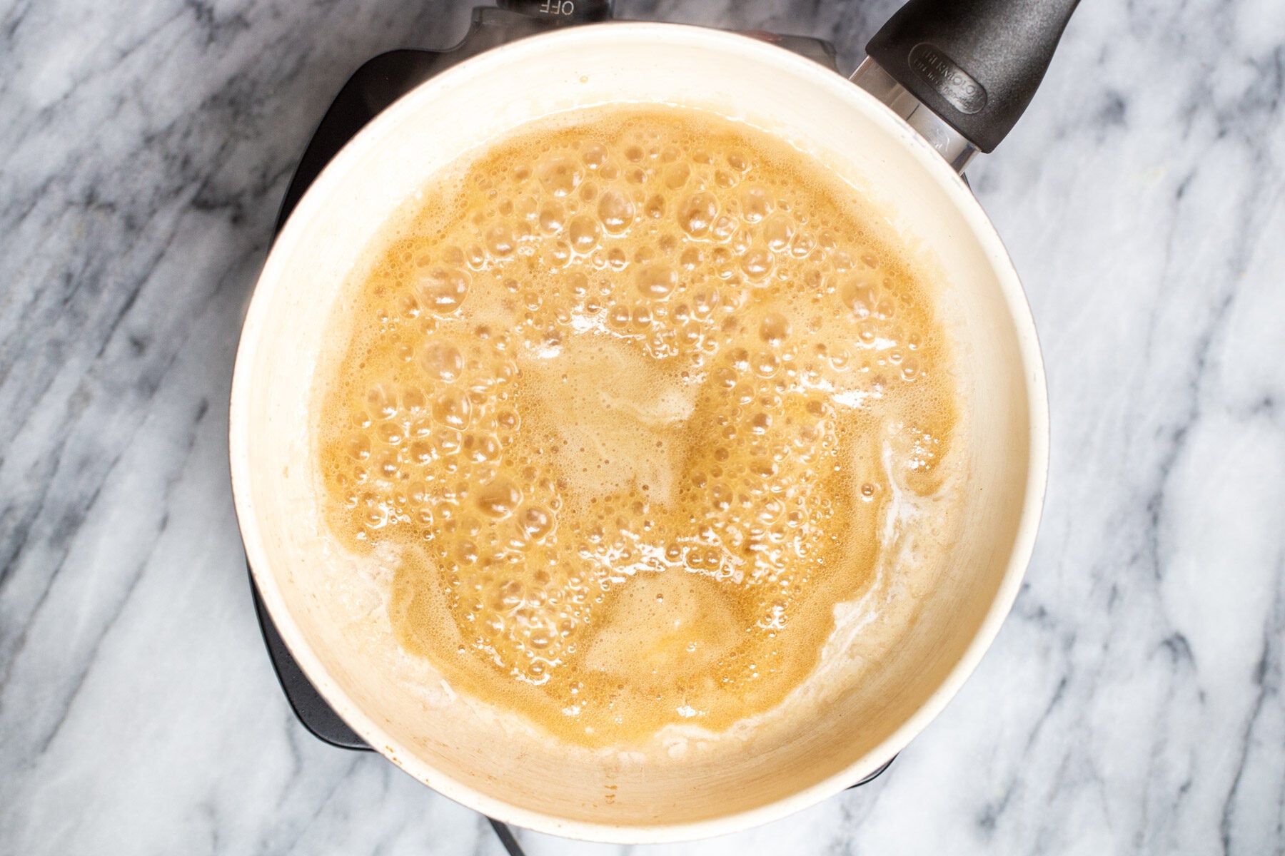 maple syrup and melted coconut cream simmering in a pan