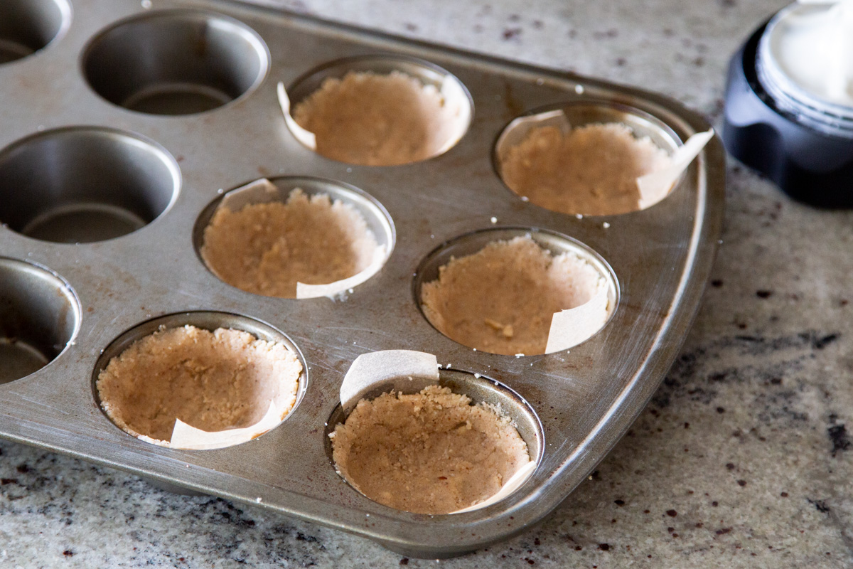 a muffin tin with 6 vegan pastry crusts ready for baking