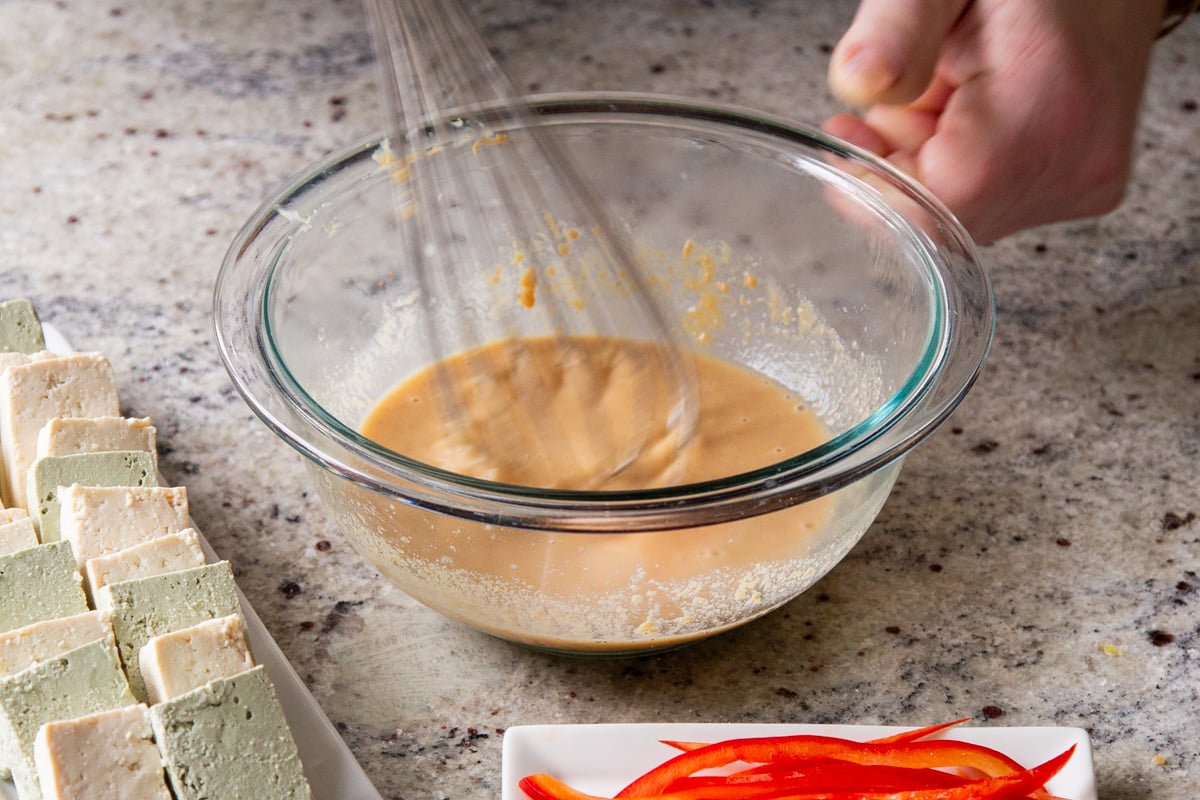 peanut coating for tofu being mixed in a bowl