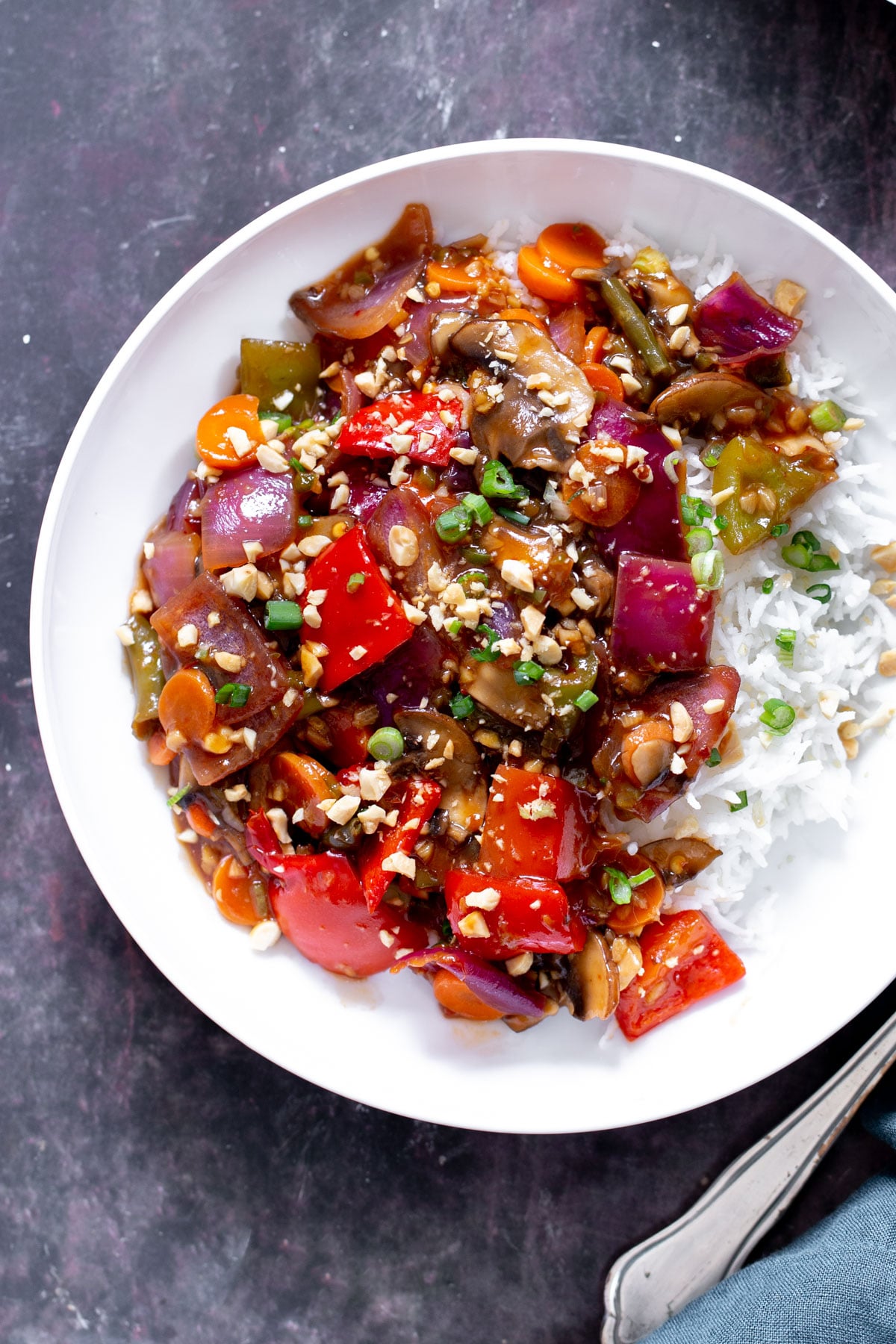 a plate of Indo Chinese Sweet & Spicy veggies served with rice