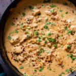 vegan kasuri malai murg in the pan, after cooking with fresh herbs sprinkled on top