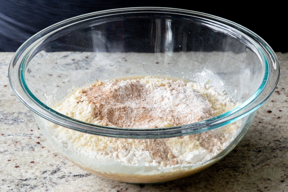 adding the remaining dry cake ingredients to the mixing bowl